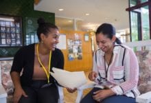 Students and a teacher going over a lesson plan