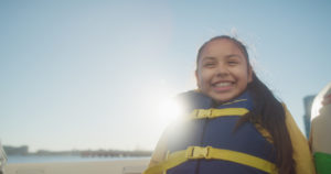 girl on boat with life vest