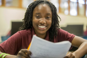 girl smiling with papers