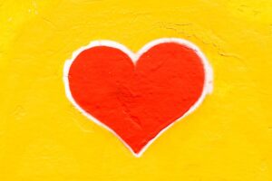 Red heart on yellow background