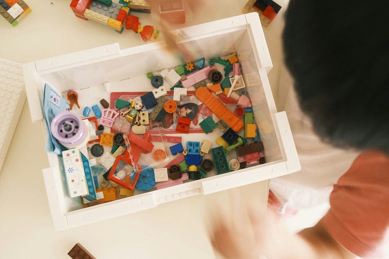 legos and building blocks in a plastic bin