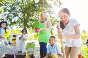 students gardening with educator
