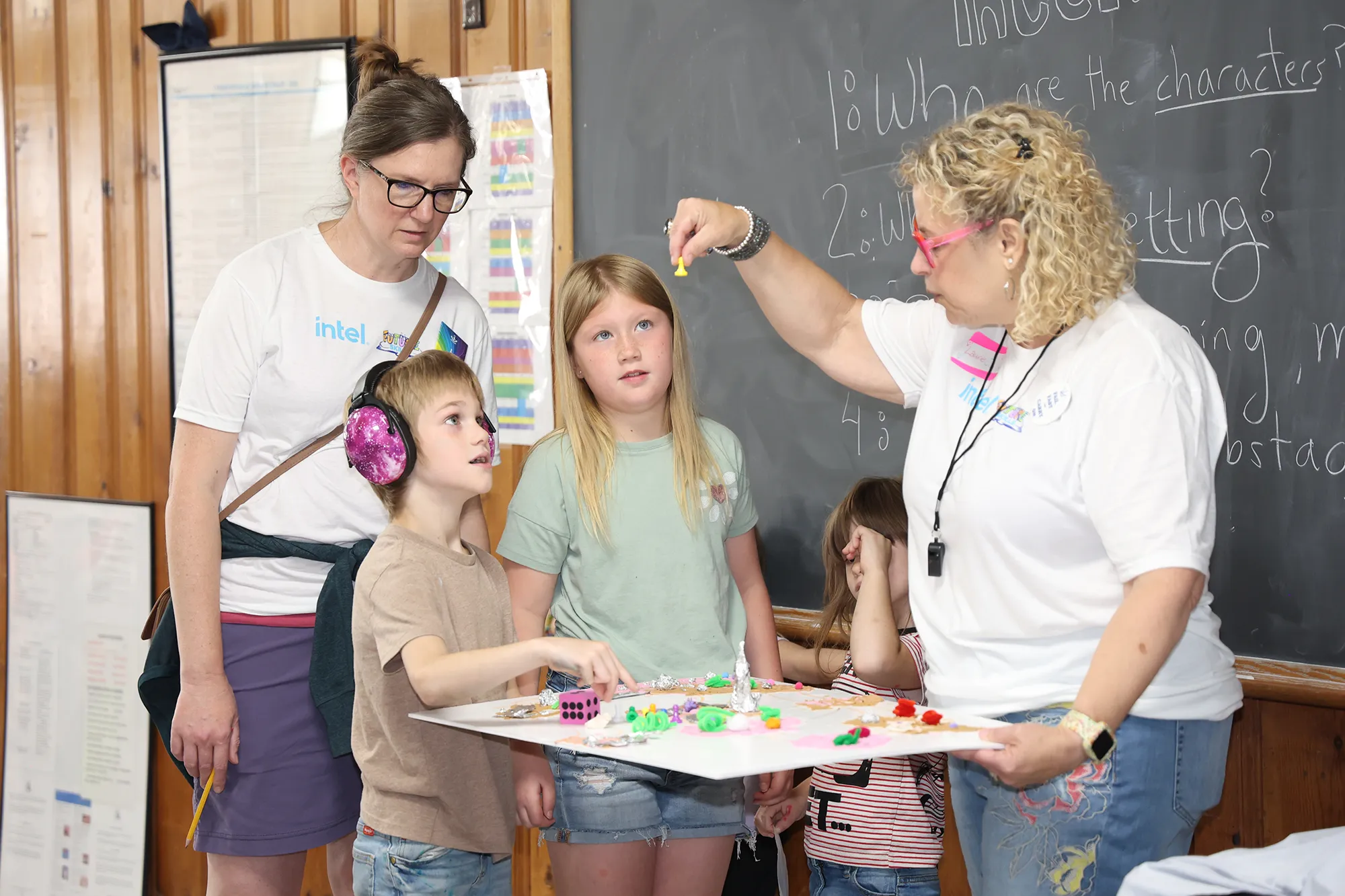 woman instructs two children