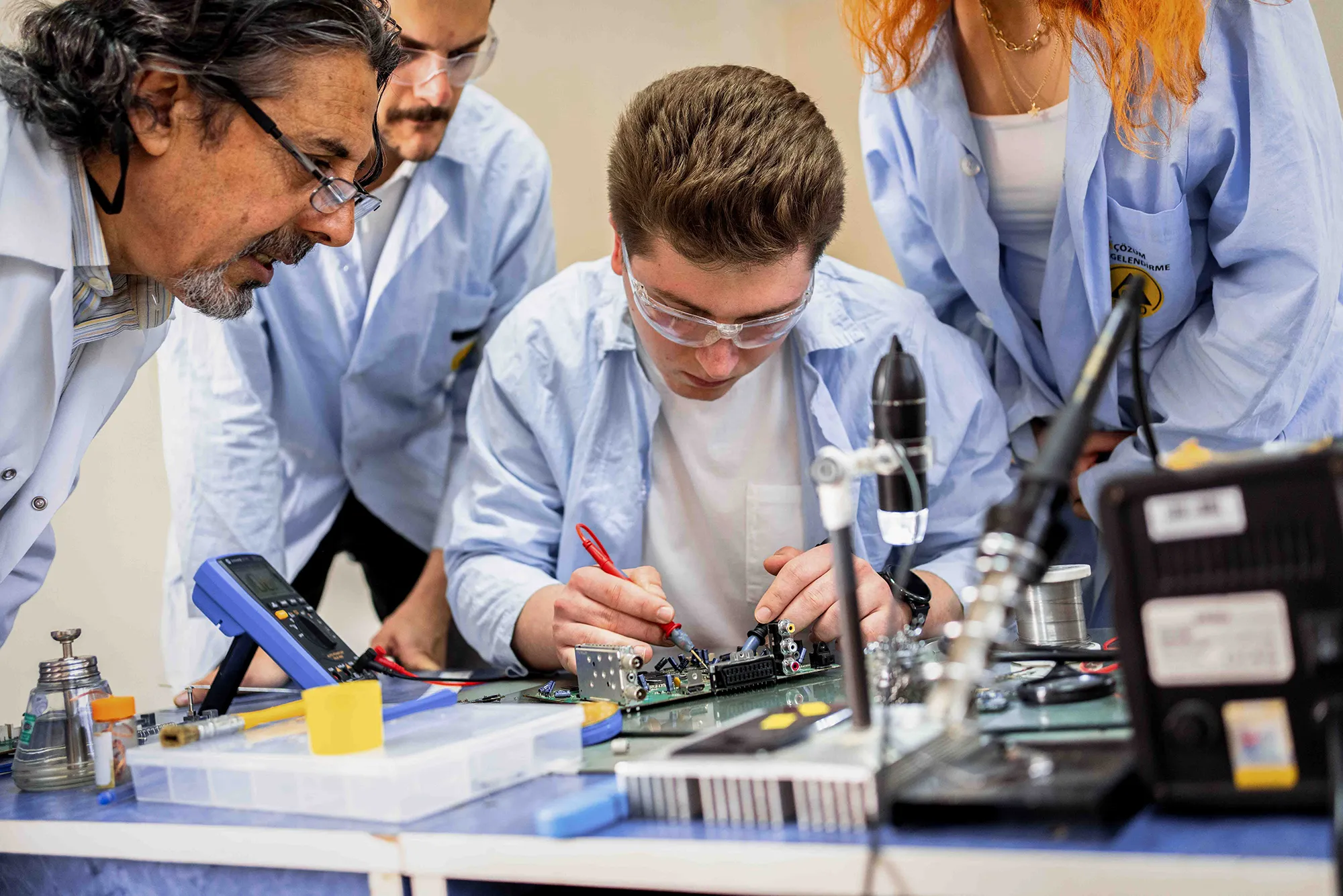 students interact with circuits with teacher