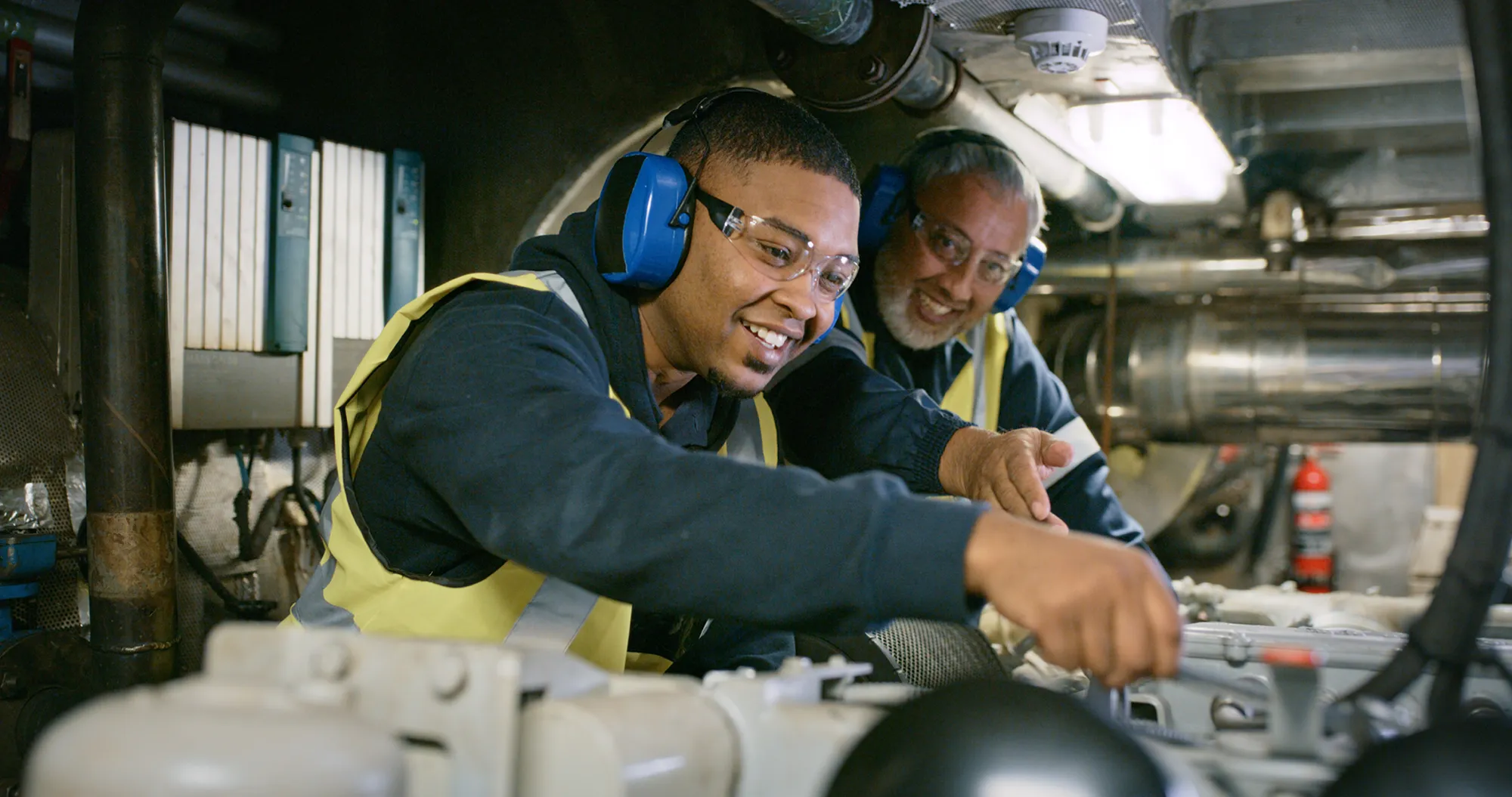 Man and teen work on electrical work together