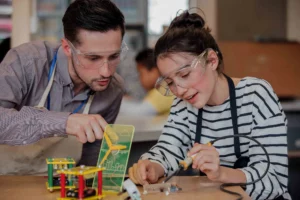 teen and teacher work on circuits together