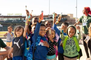 kids hold up their projects in the air