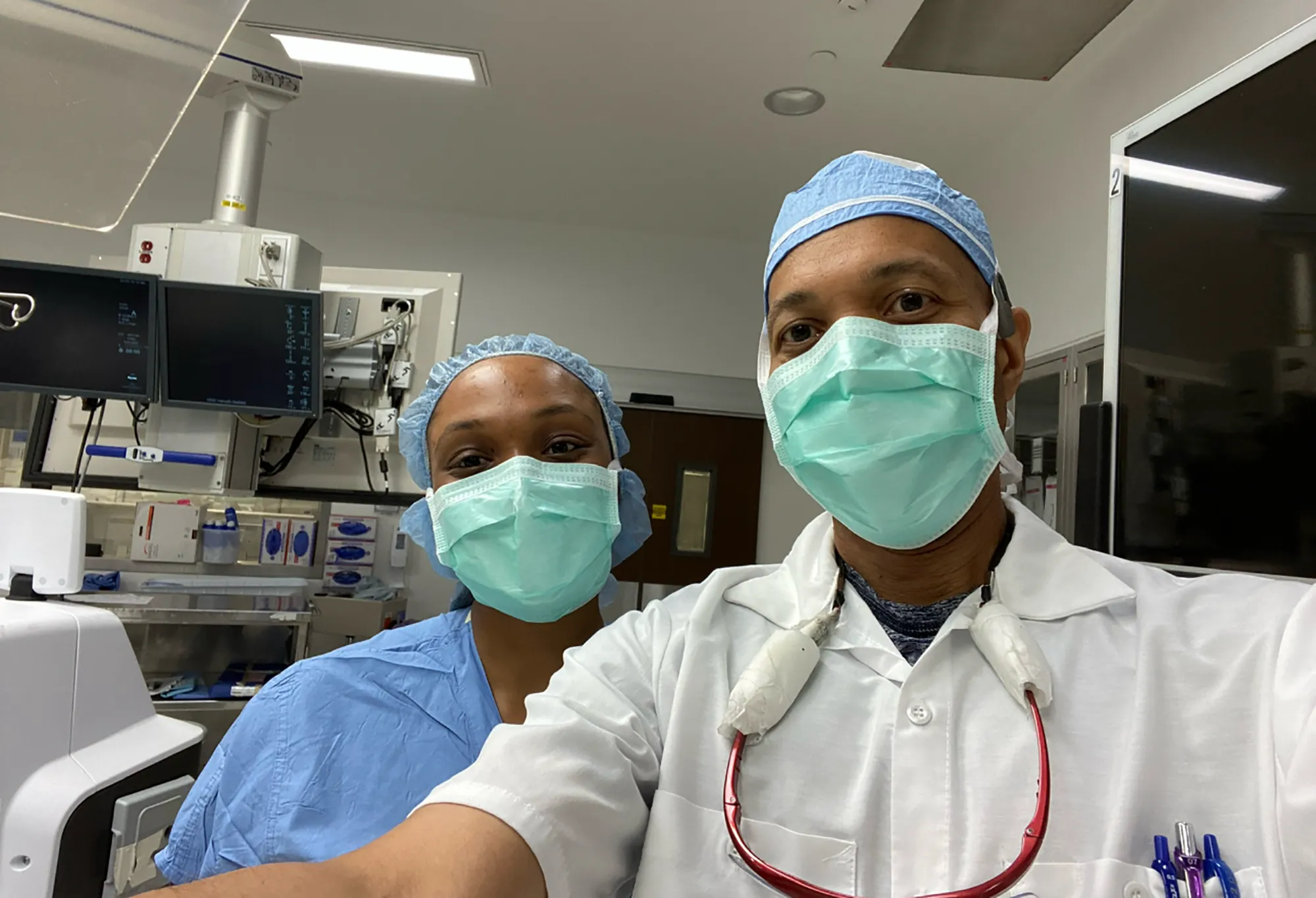 two people take selfie in operating room