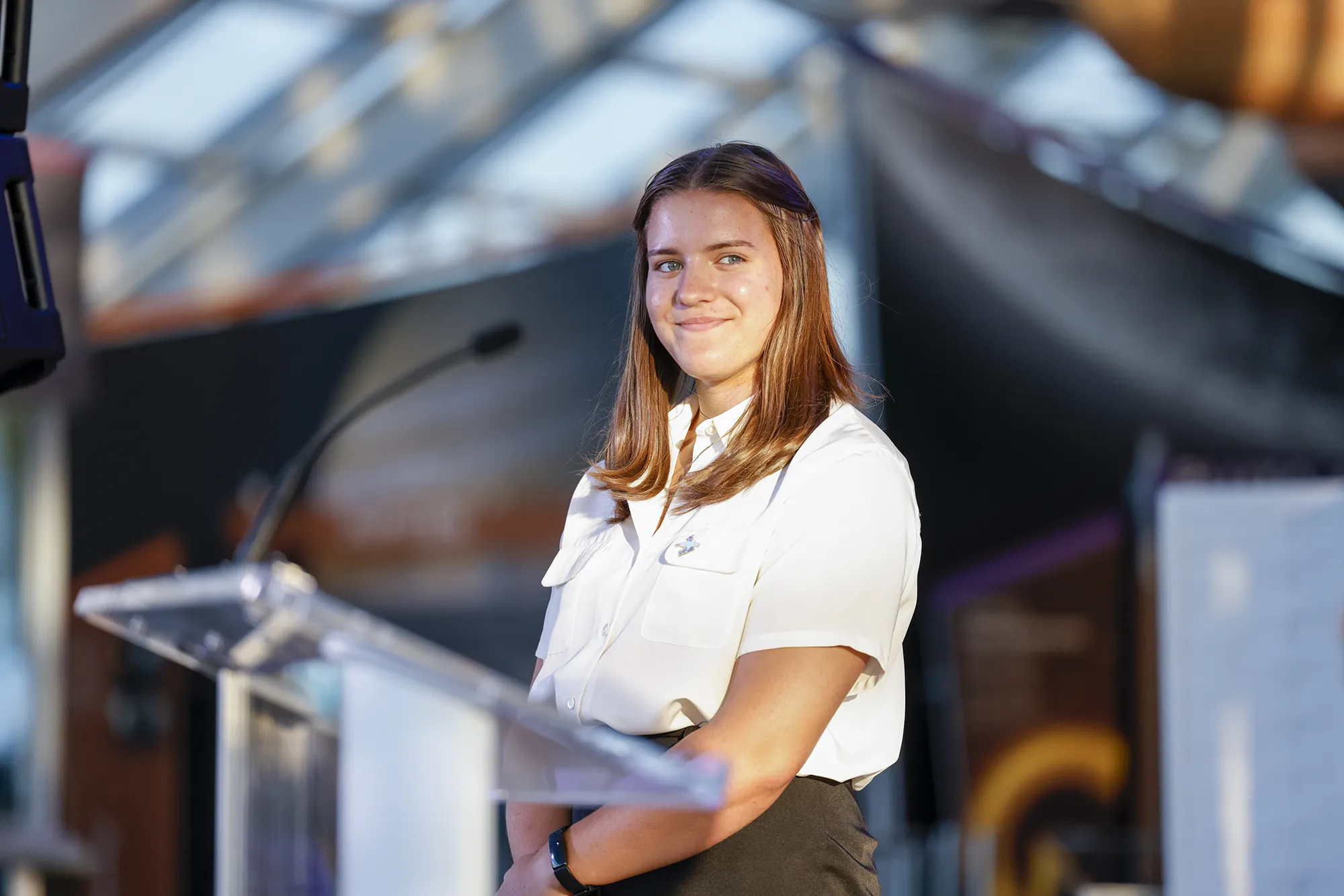 girl stands a podium