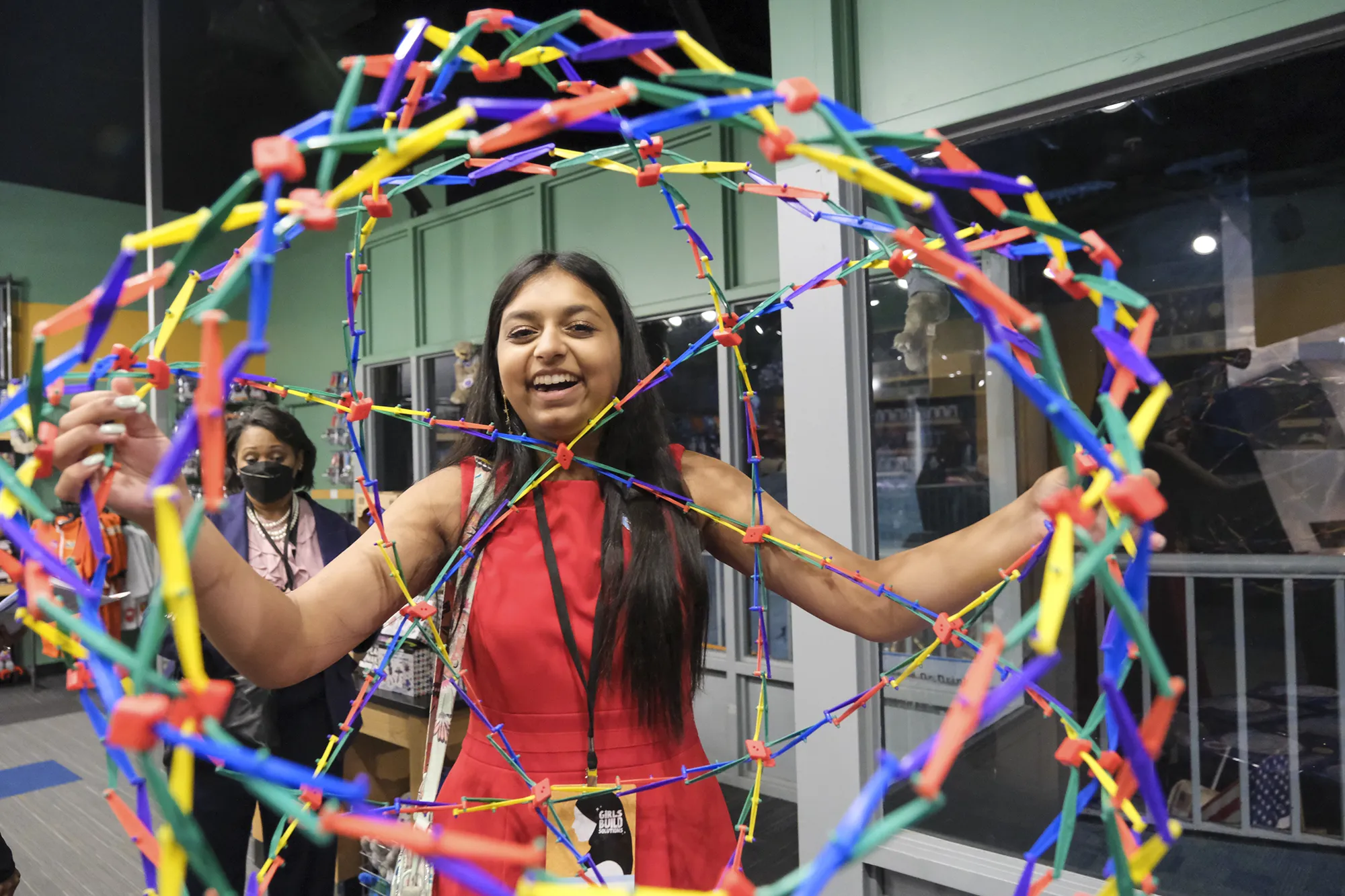 teen girl smiling with STEM project