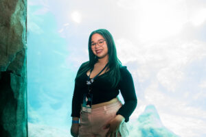 girl posts in front of fish tank