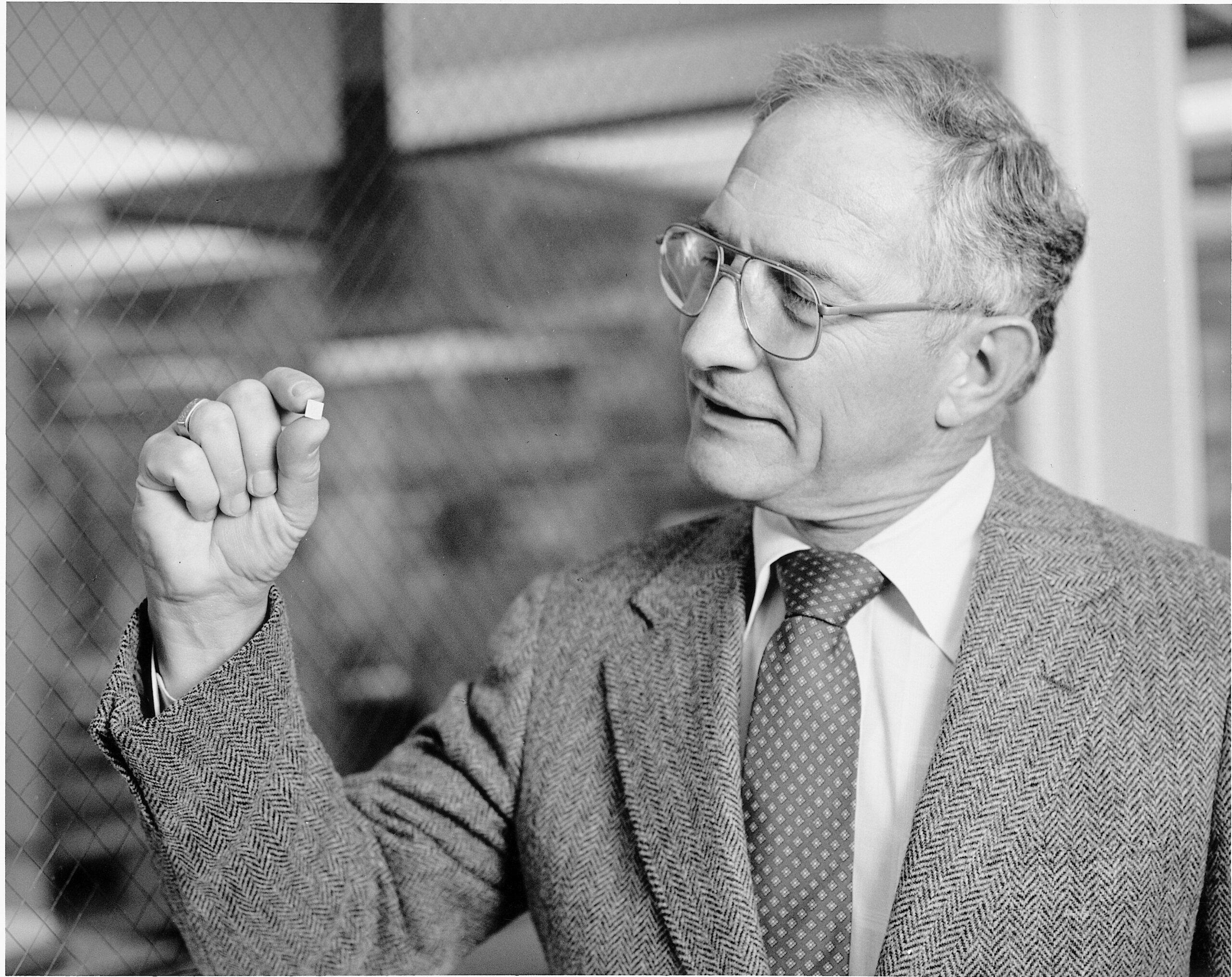 Mr. Noyce looking at a microchip