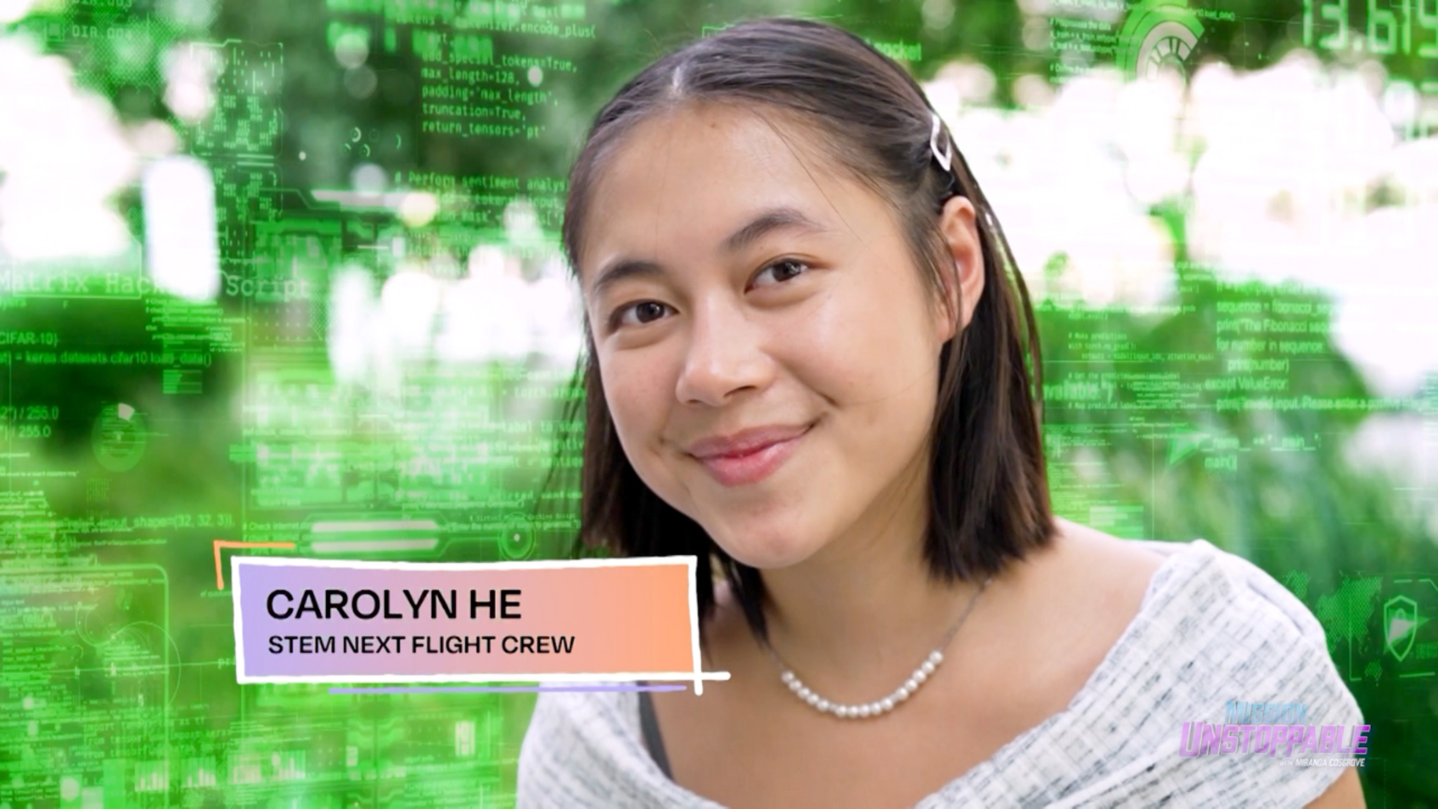 A young woman with straight brown hair, wearing a pearl necklace and a light sweater, smiles at the camera. The background features green digital code and graphics. A text box reads CAROLYN HE, STEM NEXT FLIGHT CREW.